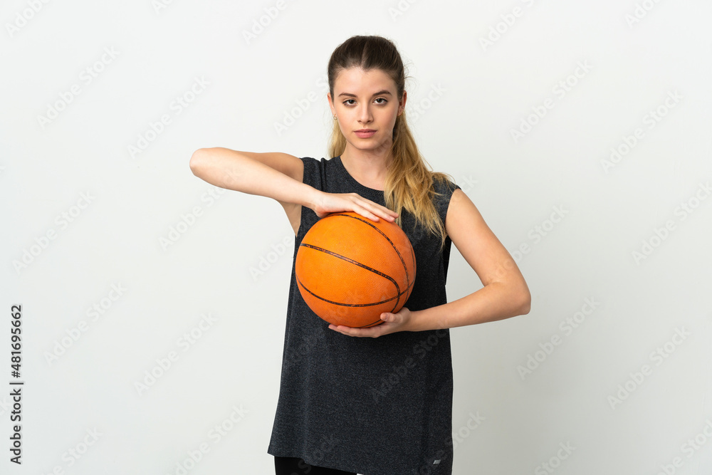 Young blonde woman isolated on white background playing basketball Young blonde woman isolated on white background playing basketball
