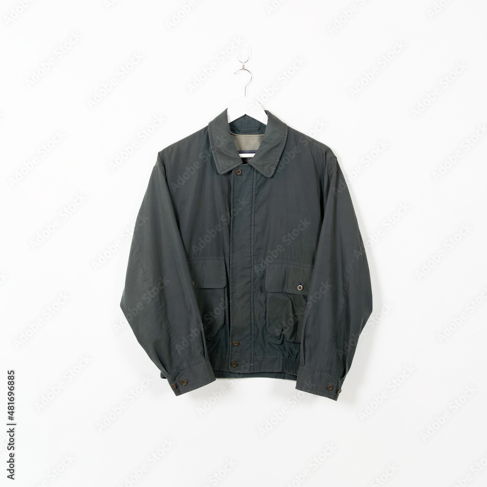 Blank clothes hanging in center empty white wall. Clear label mockup with highly detailed texture materials. Square. Blank clothes hanging in center empty white wall. Clear label mockup with highly detailed texture materials. Square.
