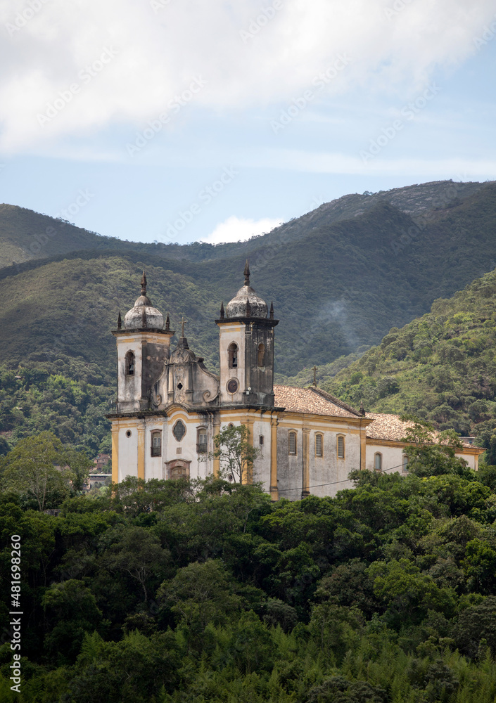 View of the Church of São Francisco de Paula, with mountains in the background. Historic city of Ouro Preto, Minas Gerais. Portuguese colonial village, capital of Brazil in the Golden Age.