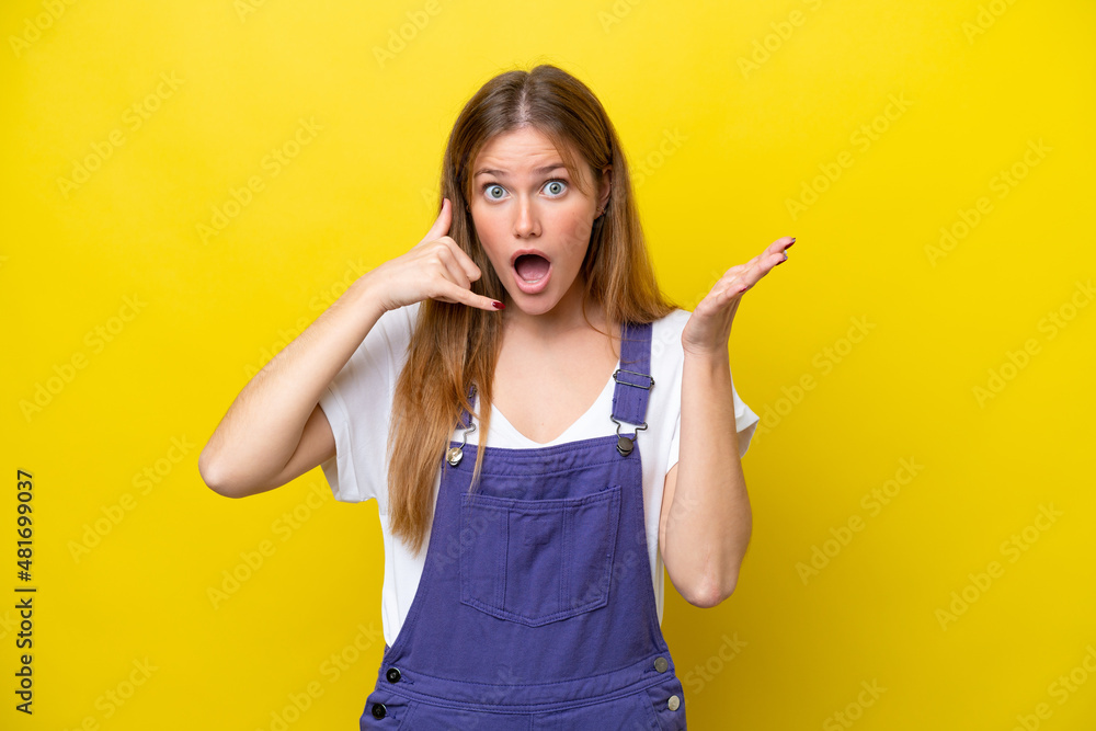 Young caucasian woman isolated on yellow background making phone gesture and doubting Young caucasian woman isolated on yellow background making phone gesture and doubting