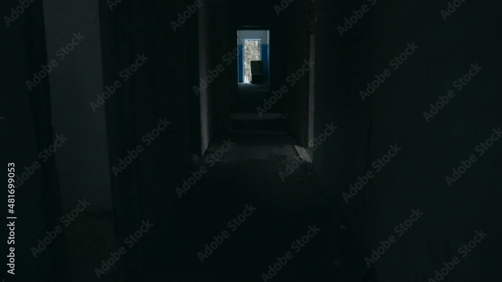 Walking down a dark corridor in an old abandoned building Walking down a dark corridor in an old abandoned building