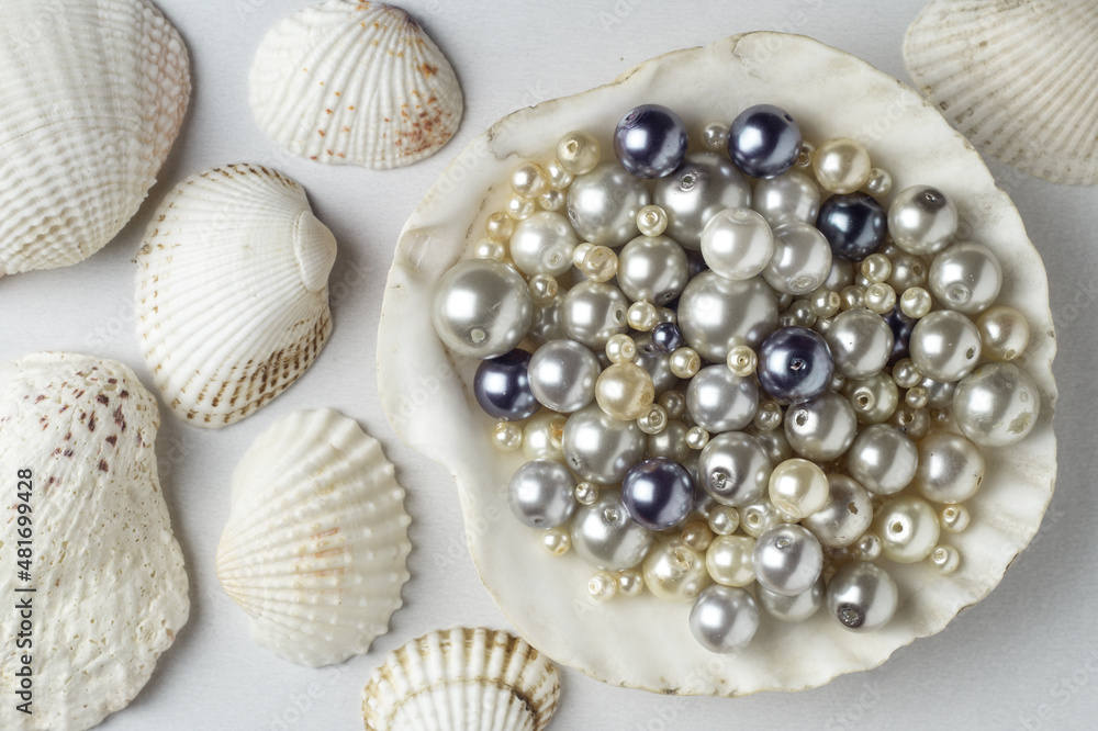 Various pearl beads in a large shell Various pearl beads in a large shell