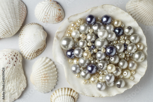 Various pearl beads in a large shell