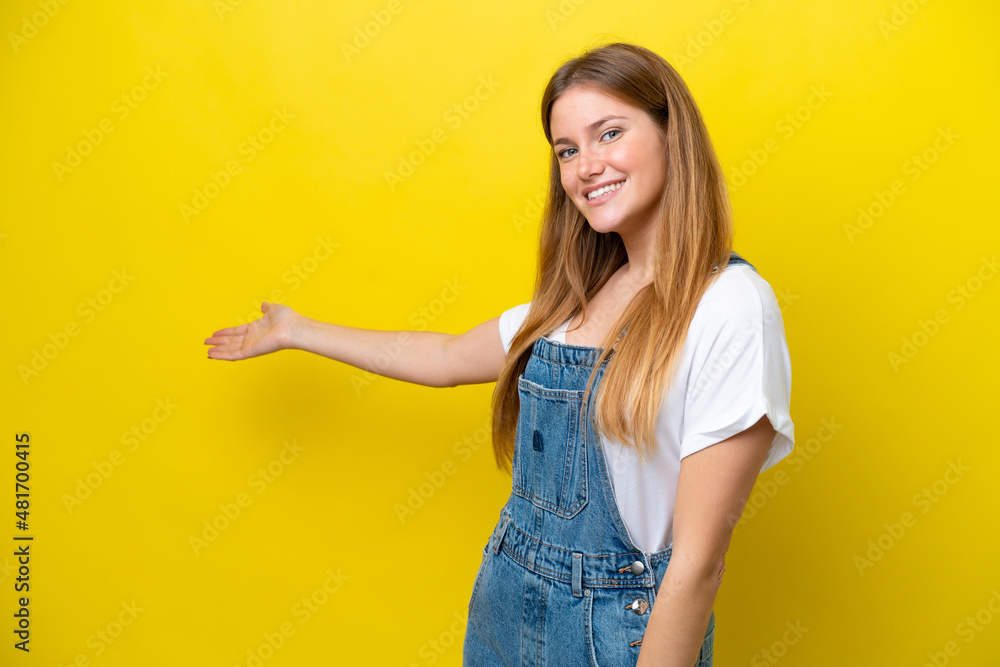 Young caucasian woman isolated on yellow background extending hands to the side for inviting to come Young caucasian woman isolated on yellow background extending hands to the side for inviting to come