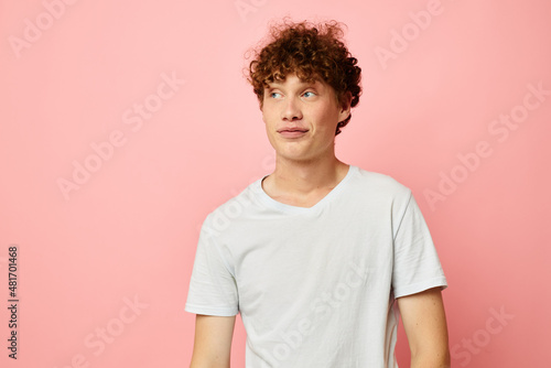 portrait of a young curly man summer clothes white tshirt posing Lifestyle unaltered © Tatiana