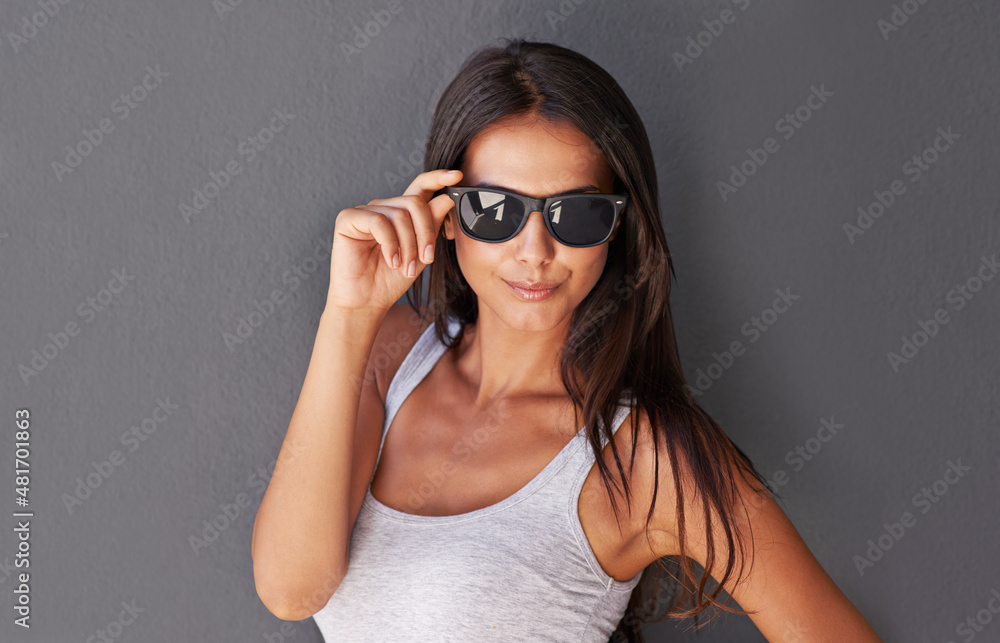 Confident in her beauty. Shot of a beautiful young woman wearing sunglasses being flirty. Confident in her beauty. Shot of a beautiful young woman wearing sunglasses being flirty.