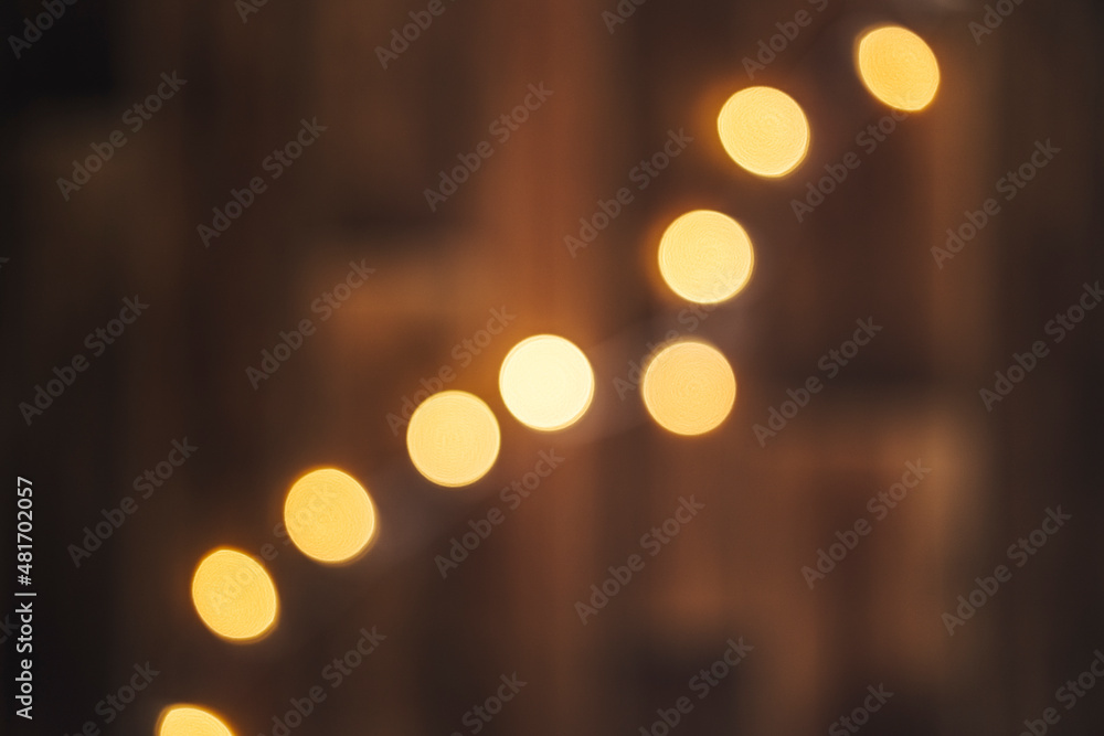 Out of focus wooden background with bokeh lights on it. Christmass abstract background. - obrazy, fototapety, plakaty 