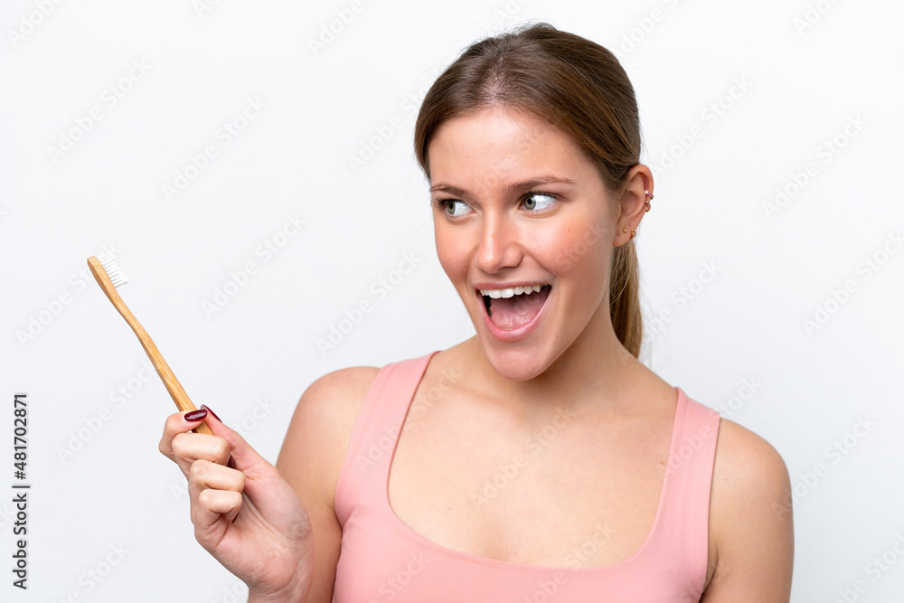 Young caucasian woman isolated on white background with a toothbrush and surprised expression Young caucasian woman isolated on white background with a toothbrush and surprised expression