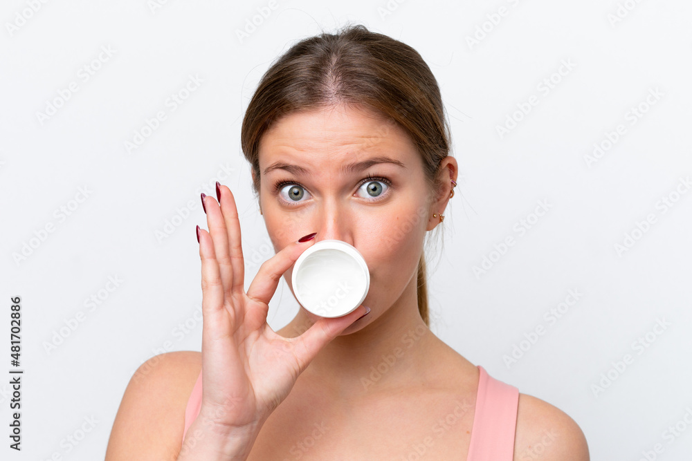 Young caucasian woman isolated on white background with moisturizer Young caucasian woman isolated on white background with moisturizer