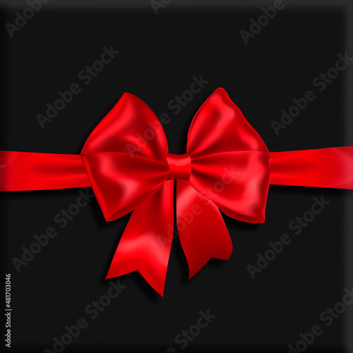 Dark gray background with a red festive bow.