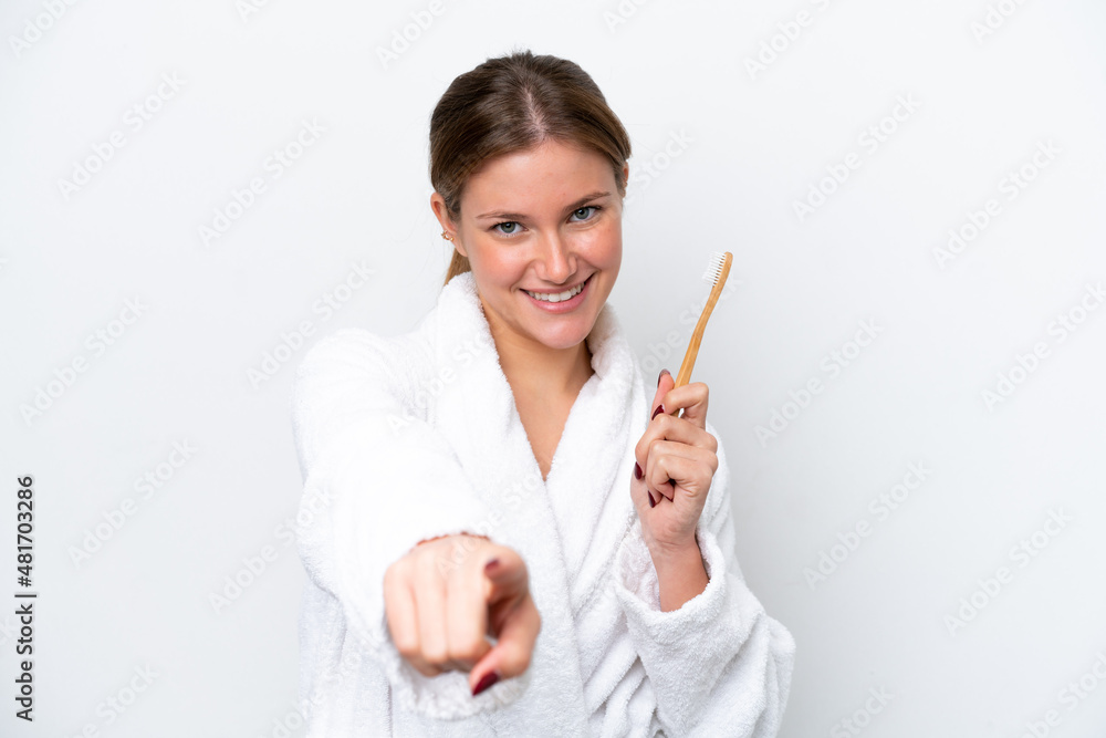 Young caucasian woman brushing teeth isolated on white background points finger at you with a confident expression Young caucasian woman brushing teeth isolated on white background points finger at you with a confident expression
