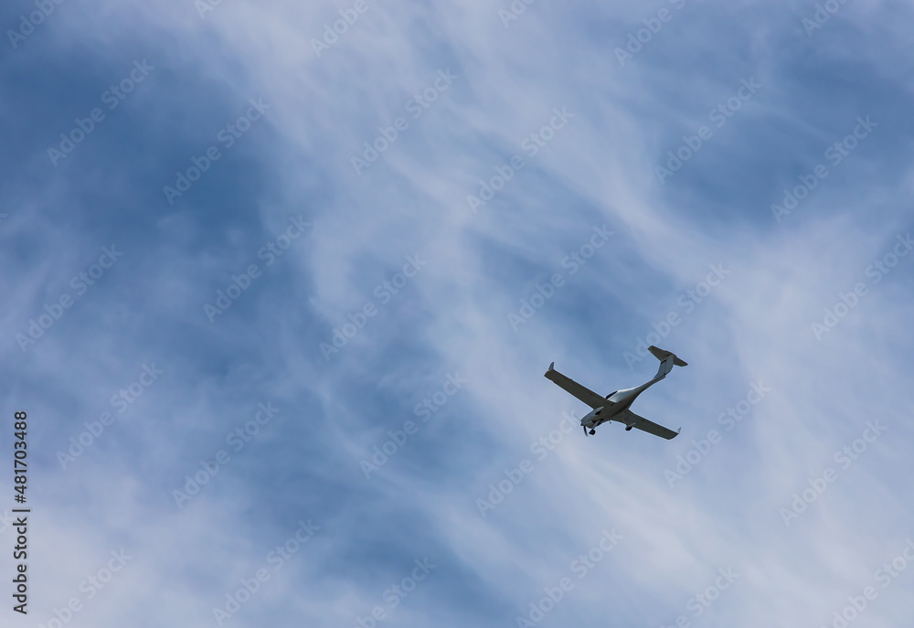 small plane flying low in the sky with space for text