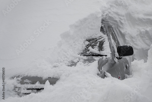 car covered with snow after a heavy snow storm.Vehicles are covered with snow during a heavy snowfall.