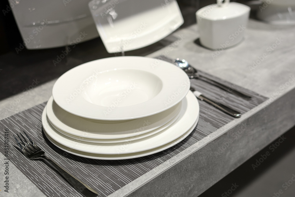 elegant luxury tableware is sold in the supermarket. Beautiful table setting on grey background elegant luxury tableware is sold in the supermarket. Beautiful table setting on grey background