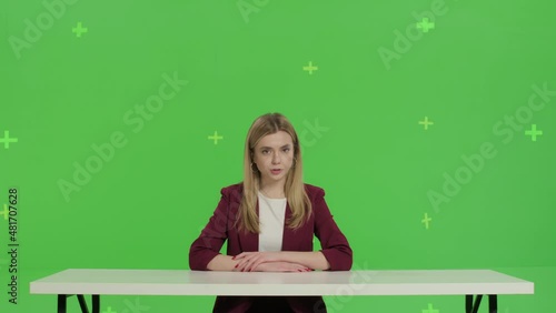 Female news presenter in broadcasting studio over green screen background photo