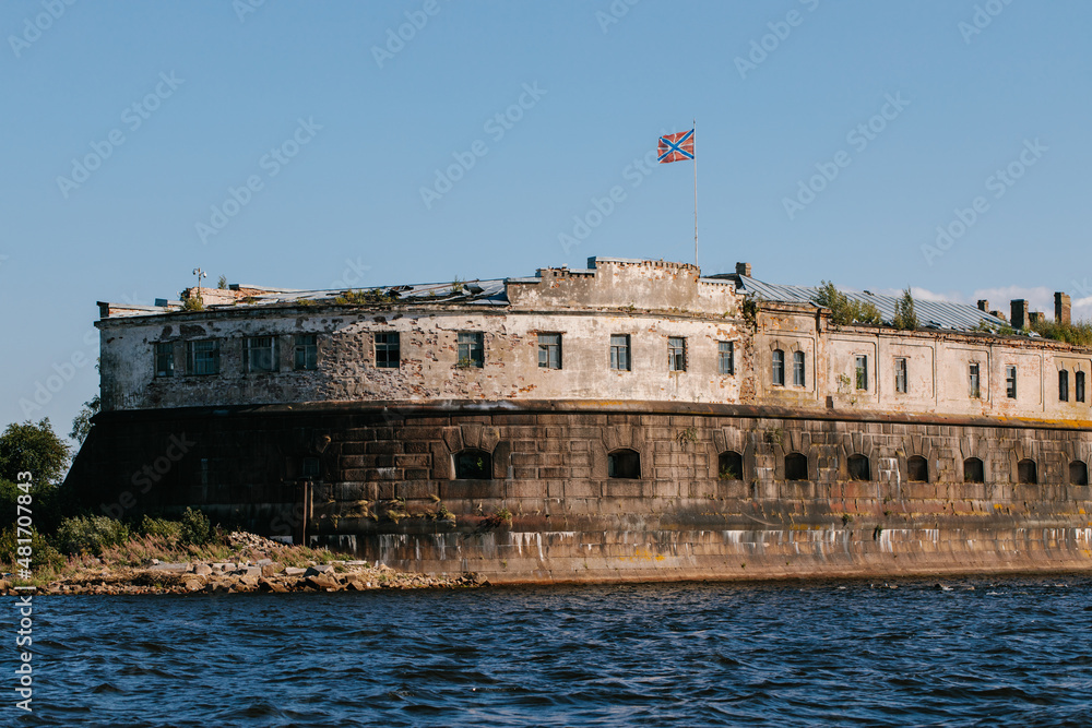 View from the water of the oldest fort Kronshlot and the lower sash lighthouse in the waters of the Gulf of Finland in Kronstadt, crown castle, defensive fortress.