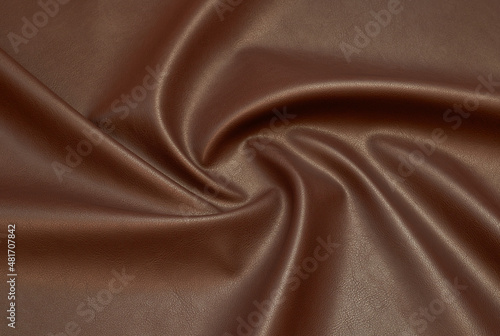 brown artificial leather with waves and folds on PVC base