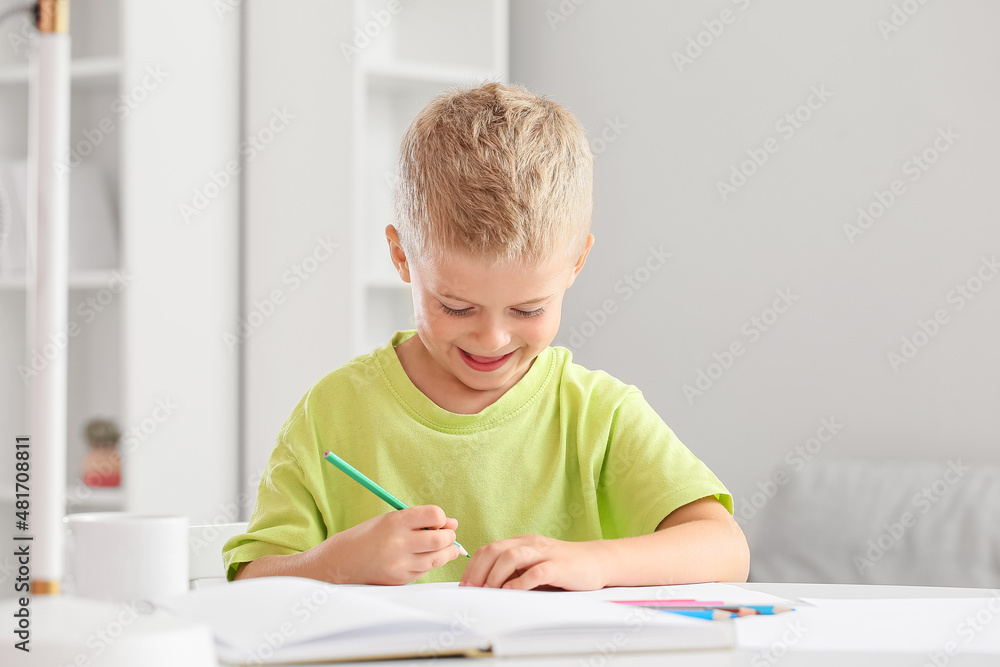 Cute little boy drawing with pencil at home Cute little boy drawing with pencil at home