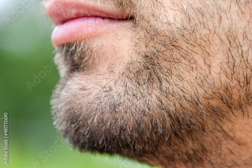 Billede på lærred Bearded male chin. Beard on the face of a young man.