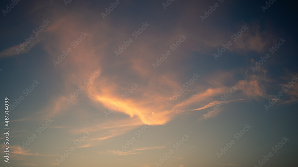 Wonderful view of cumulus clouds sky with orange sun light at sunset of summer Wonderful view of cumulus clouds sky with orange sun light at sunset of summer