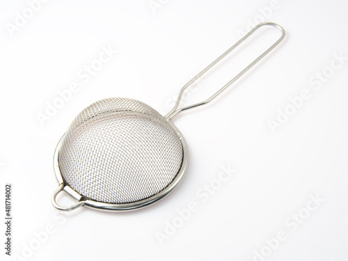 Colander with handle isolated on white background. Silver sieve