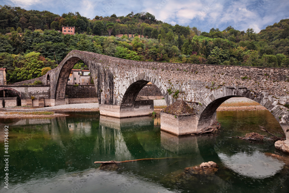 Borgo a Mozzano, Lucca, Tuscany, Italy: the medieval Ponte della Maddalena, known as Bridge of the Devil, which crosses the Serchio river on the ancient pilgrimage route Via Francigena