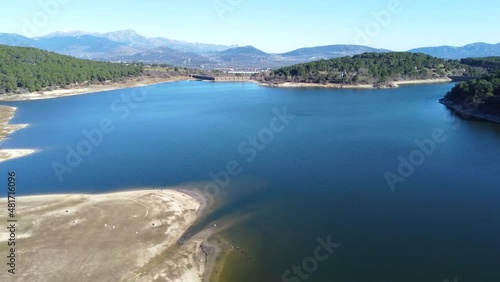 Nice aerial view slowly rising over the Jarosa reservoir in the mountain range of Madrid, located in a beautiful natural environment of the Sierra de Guadarrama, travel, concepts, 4k resolution