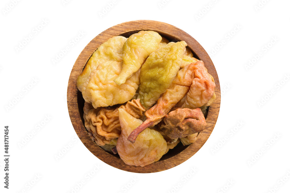 dried pears in wooden bowl isolated on white background. Vegan food, top view. dried pears in wooden bowl isolated on white background. Vegan food, top view.