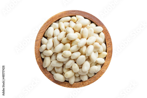 peanut peeled in wooden bowl isolated on white background. Vegan food, top view.