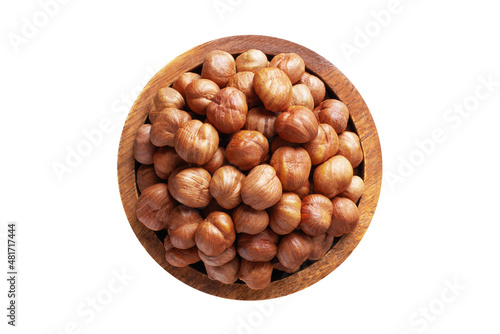hazelnut peeled raw in wooden bowl isolated on white background. Vegan food, top view.