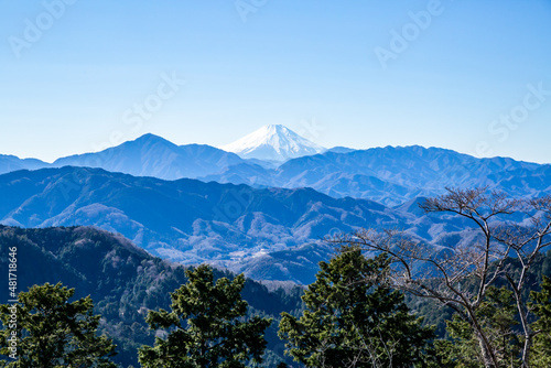 the landscape of snow-covered top of mount fuji, mountain ranges, and blue clear sky
