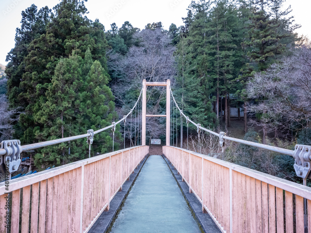 empty suspension bridge with red fences on sagami lake in kanagawa