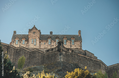 Edinburgh in Scotland, with the castle dominates the skyline, casting its shadow over the surrounding historic town occupying commanding position on volcanic crag with cliffs