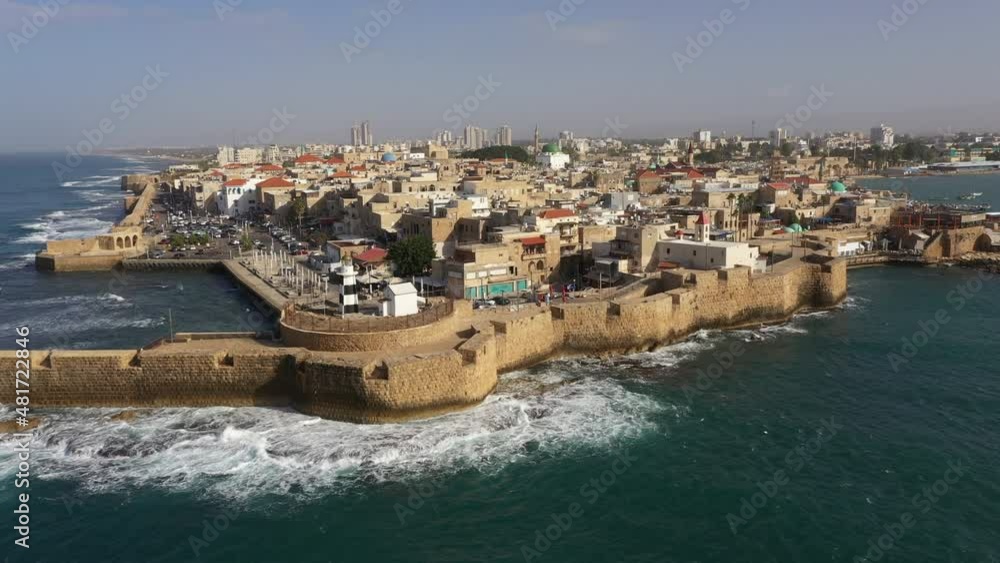 Rising drone shot of walled old city of Akko (Acre), landmarks and monuments, historical architecture and tourism in Israel
Rising drone shot of walled old city of Akko (Acre), landmarks and monuments, historical architecture and tourism in Israel