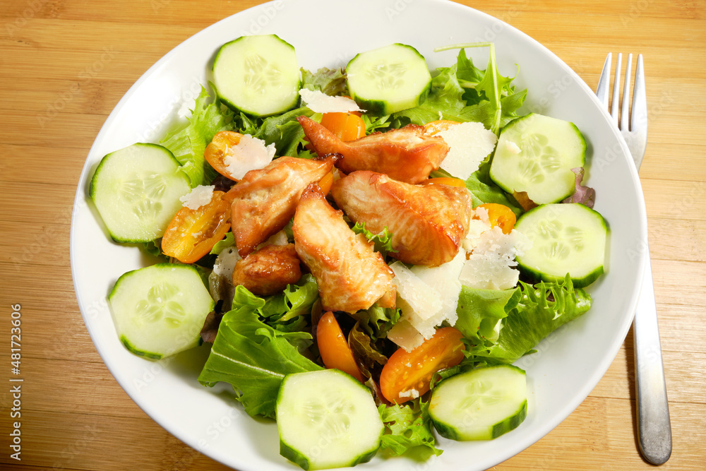 Fresh Salad with grilled cubes of teriyaki Salmon, cheese chunks on bed of spring mix lettuce with cucumber and tomatoes Fresh Salad with grilled cubes of teriyaki Salmon, cheese chunks on bed of spring mix lettuce with cucumber and tomatoes
