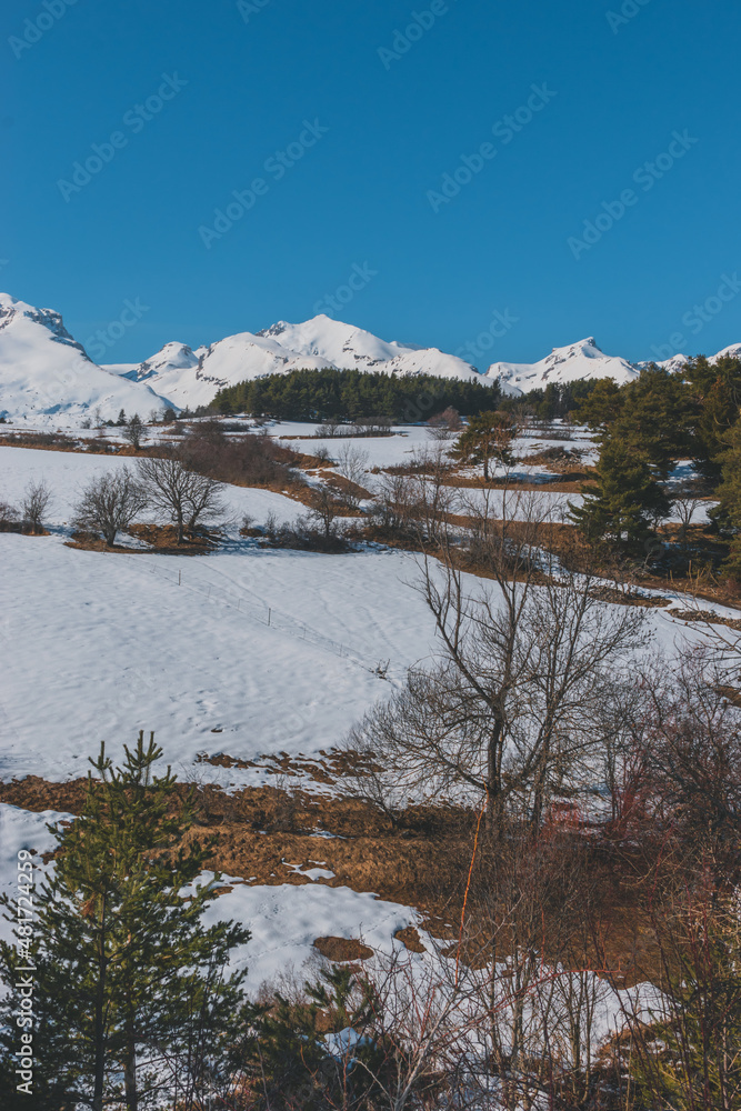 A picturesque vertical landscape view of the French Alps mountains on a cold winter day (La Joue du Loup, Devoluy) A picturesque vertical landscape view of the French Alps mountains on a cold winter day (La Joue du Loup, Devoluy)