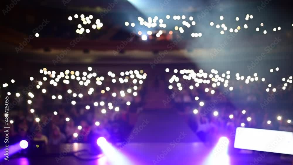 Live rock music concert crowd of people or fans shining lights or