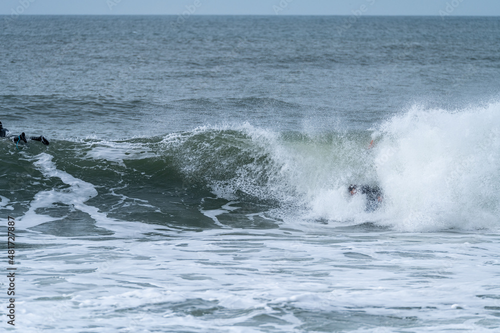 Bodyboarder performing a tube trick