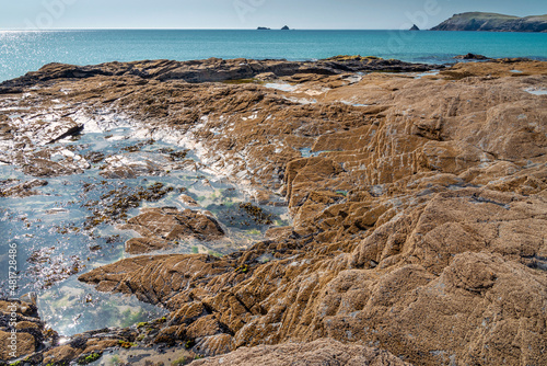 Coastal granite and rockpool,with Trevose Head in the background,Booby's Bay,North Cornwall,England,UK. photo