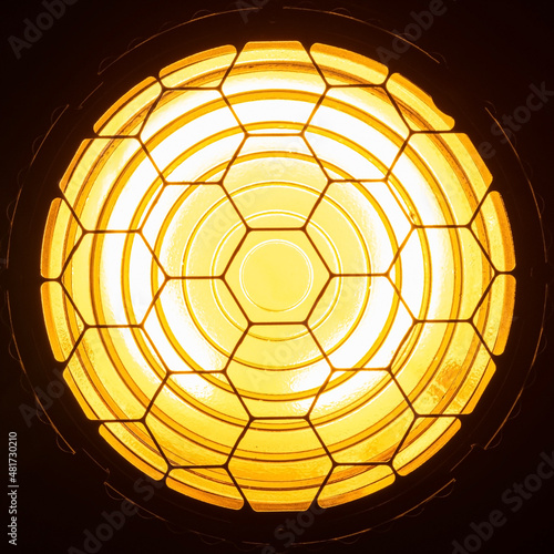 Directional yellow light from Fresnel lens closeup front view photo
