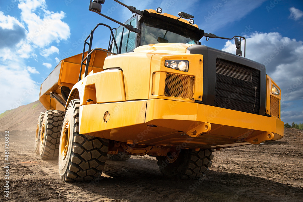 Yellow dump truck on the construction site