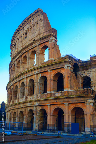 Side view of Colosseum . Ancient architecture in Rome Italy . Antique architectural arches