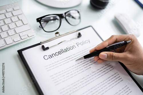 African Man Reading Business Cancel Policy photo