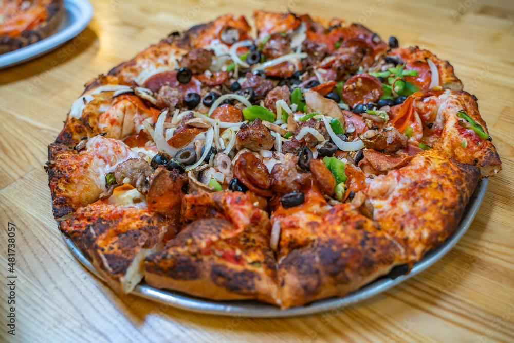 Freshly baked pizza with salami, sausages, meat, cheese, olives, pepper. Freshly baked pizza with salami, sausages, meat, cheese, olives, pepper.
