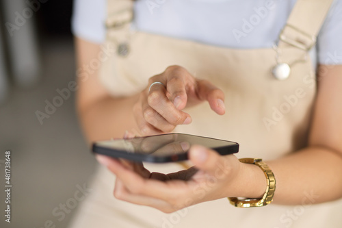 A young woman using her smartphone. cropped shot