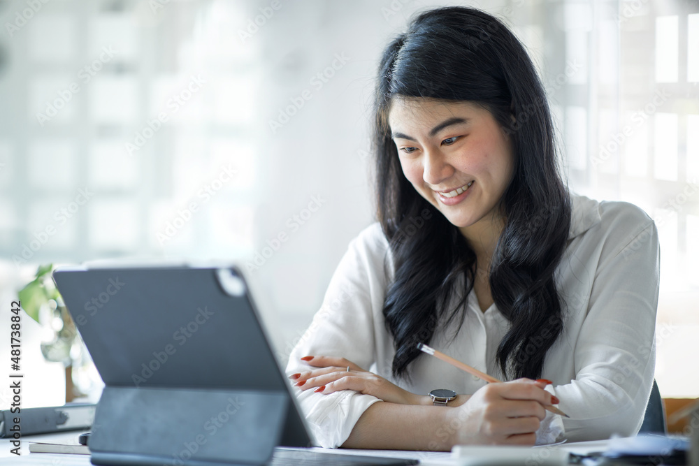 Concentrated Asian young beautiful businesswoman working on laptop in bright modern office, employee freelance online marketing e-commerce telemarketing concept. Concentrated Asian young beautiful businesswoman working on laptop in bright modern office, employee freelance online marketing e-commerce telemarketing concept.