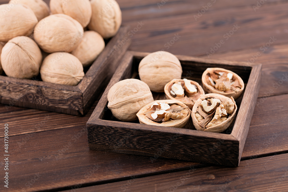 Fototapeta premium Dried walnuts are in a wooden box