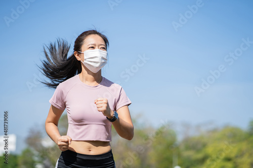 Asian women runners are wearing a mask to prevent dust, pollution, prevention, influenza, coronavirus virus in the city. Outdoor sports concept.