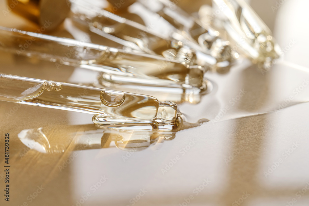 Pipettes with oil or serum on a golden background. Pipettes with oil or serum on a golden background.