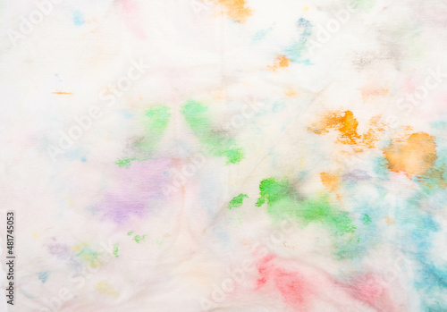Mix color of watercolor stain on white fabric paper for background.